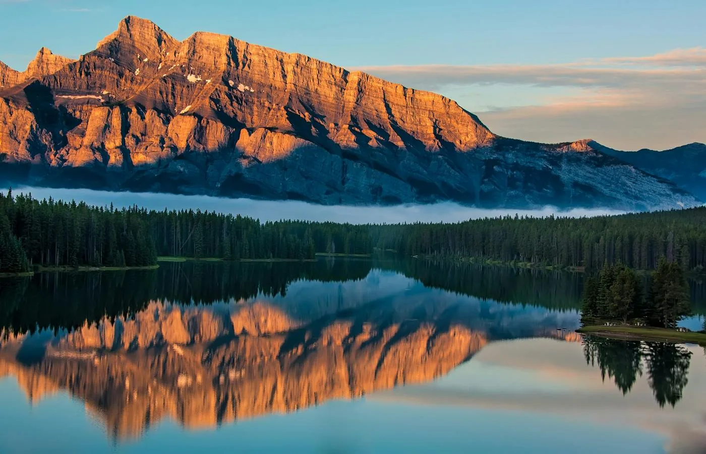 Mountain reflected in Lake Minnewanka at sunrise, Banff National Park, Alberta